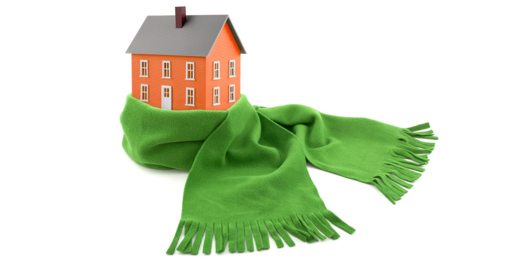 a 2 story brick home wrapped in a green scarf