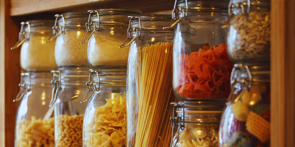 jars of pasta and grains on wooden shelf