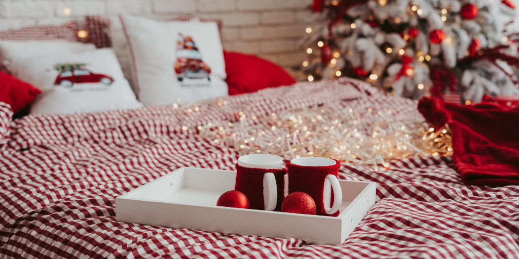 a bedroom decked out in red and white Christmas decorations