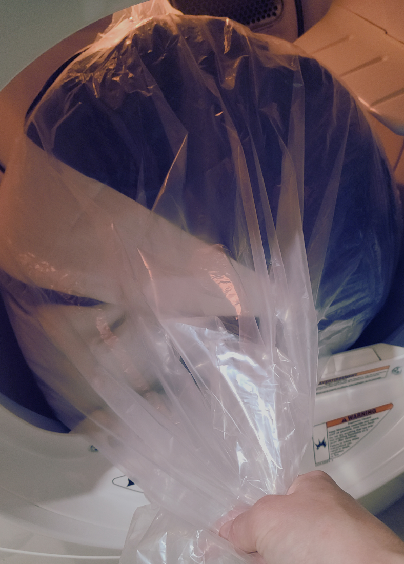 a clear bag being emptied into a dryer